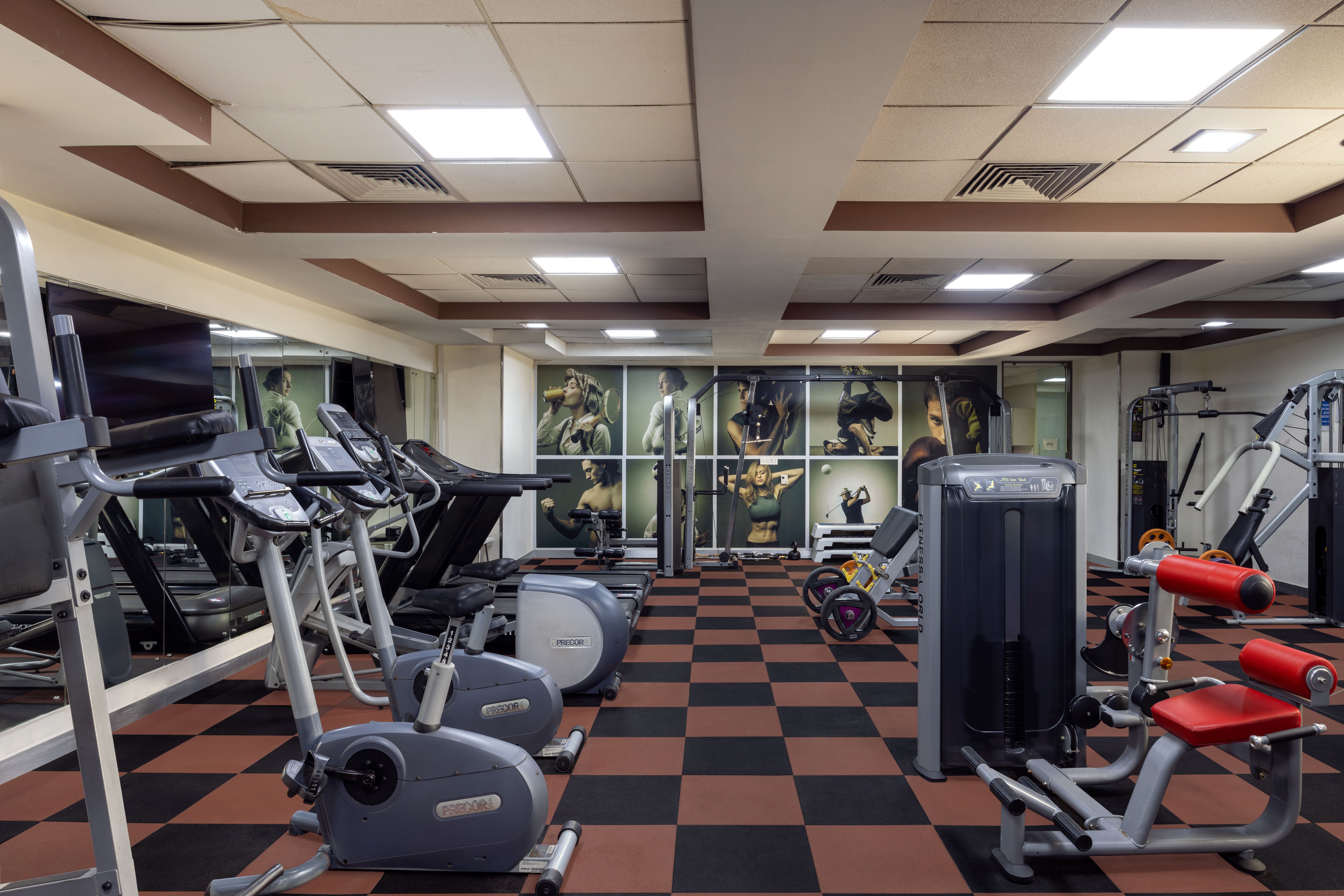 Modern gymnasium at Airtel Center, featuring fitness equipment and bright, open space.