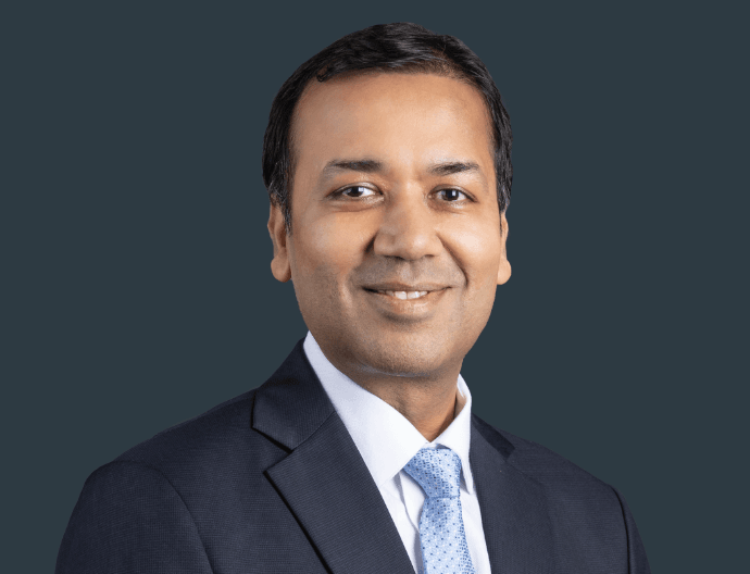 Amit Jain, Brookfield India REIT CEO, smiling professionally in an office setting.