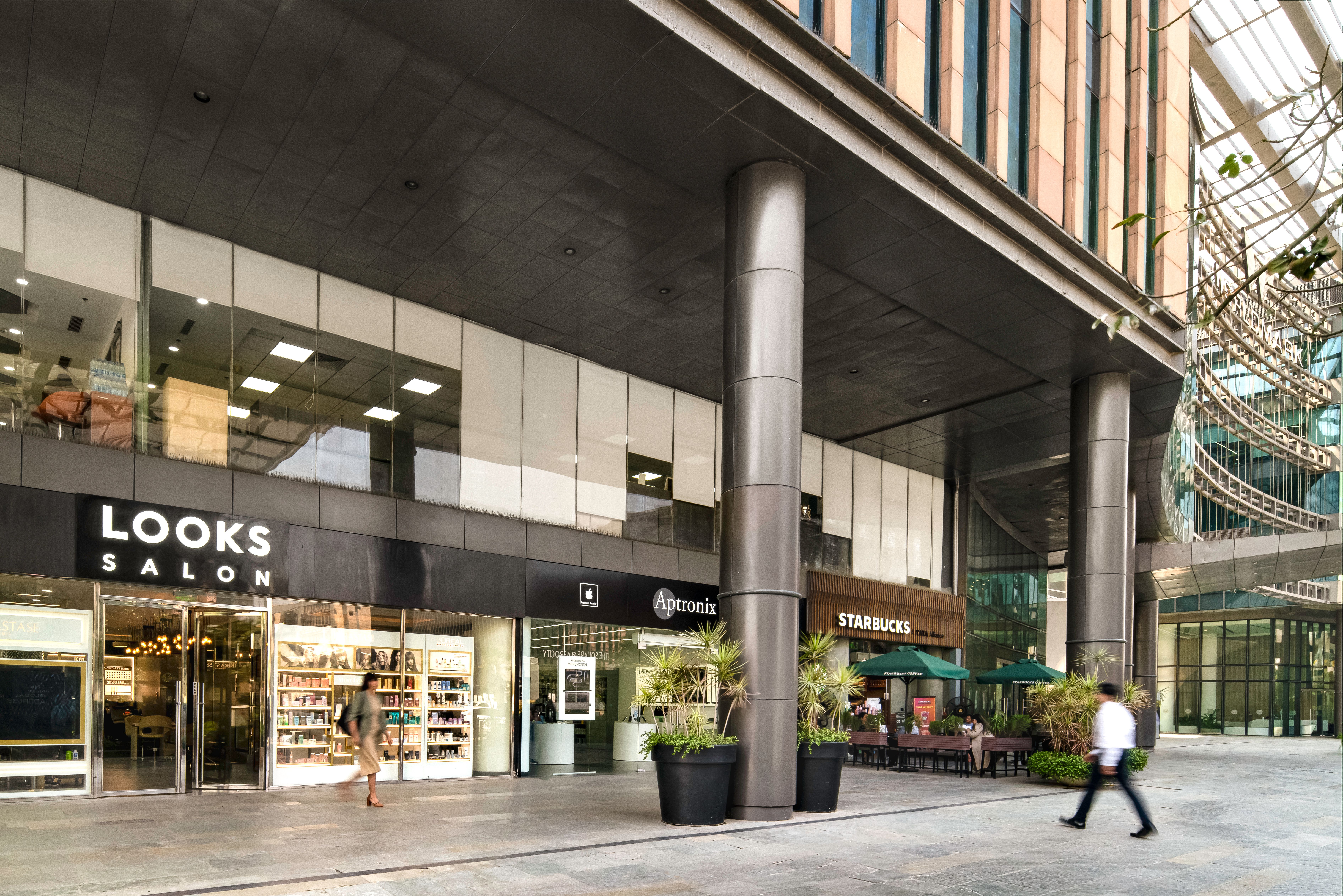 Vibrant retail space with diverse shops and food outlets, showcasing a modern shopping experience.