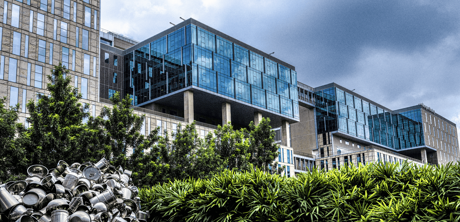 Modern office building exterior, lush greenery, sustainable design, Brookfield India REIT.