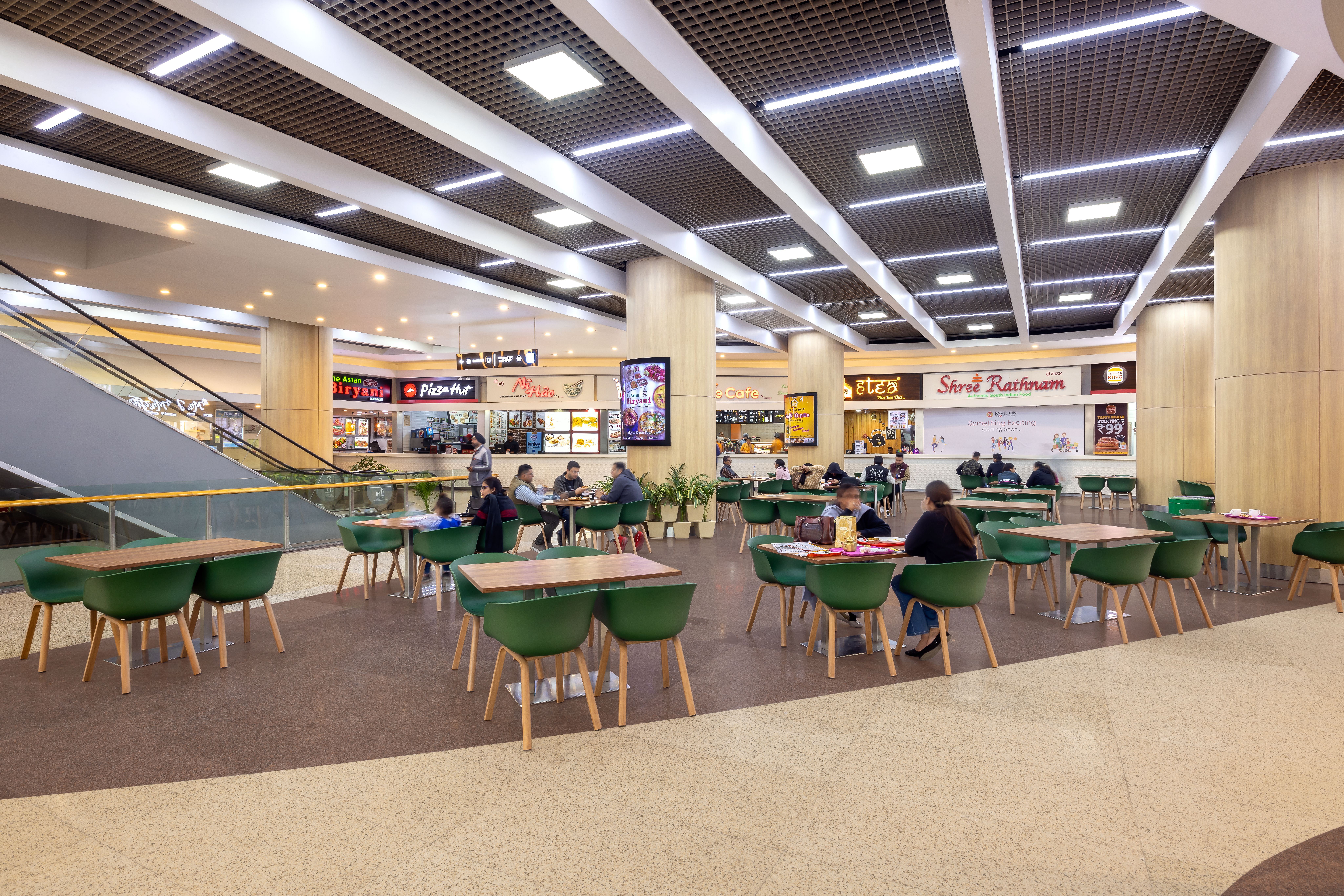 Lively food court with diverse dining options and ample seating.