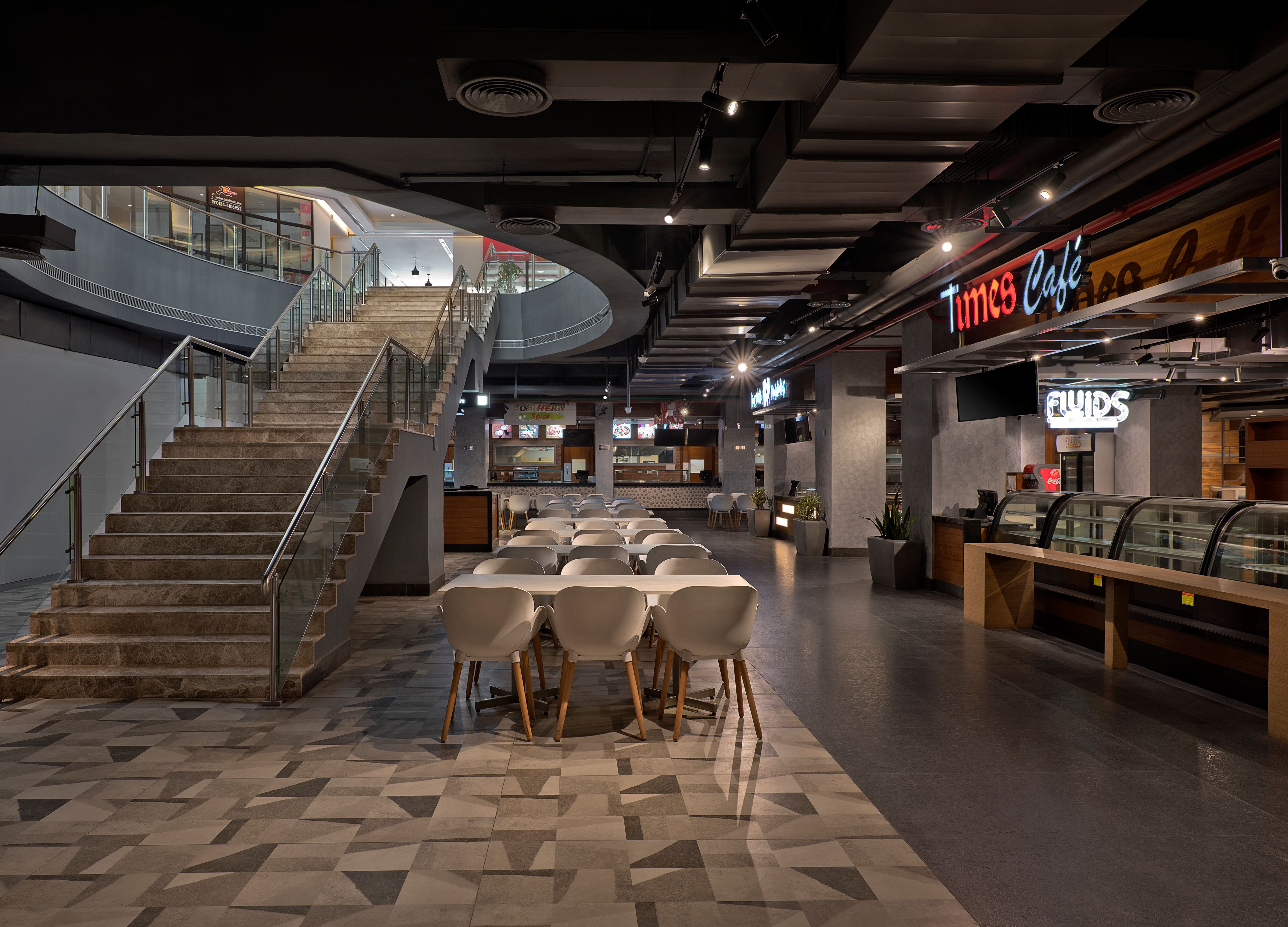 Lively food hall with diverse vendors and seating, showcasing a vibrant dining experience.