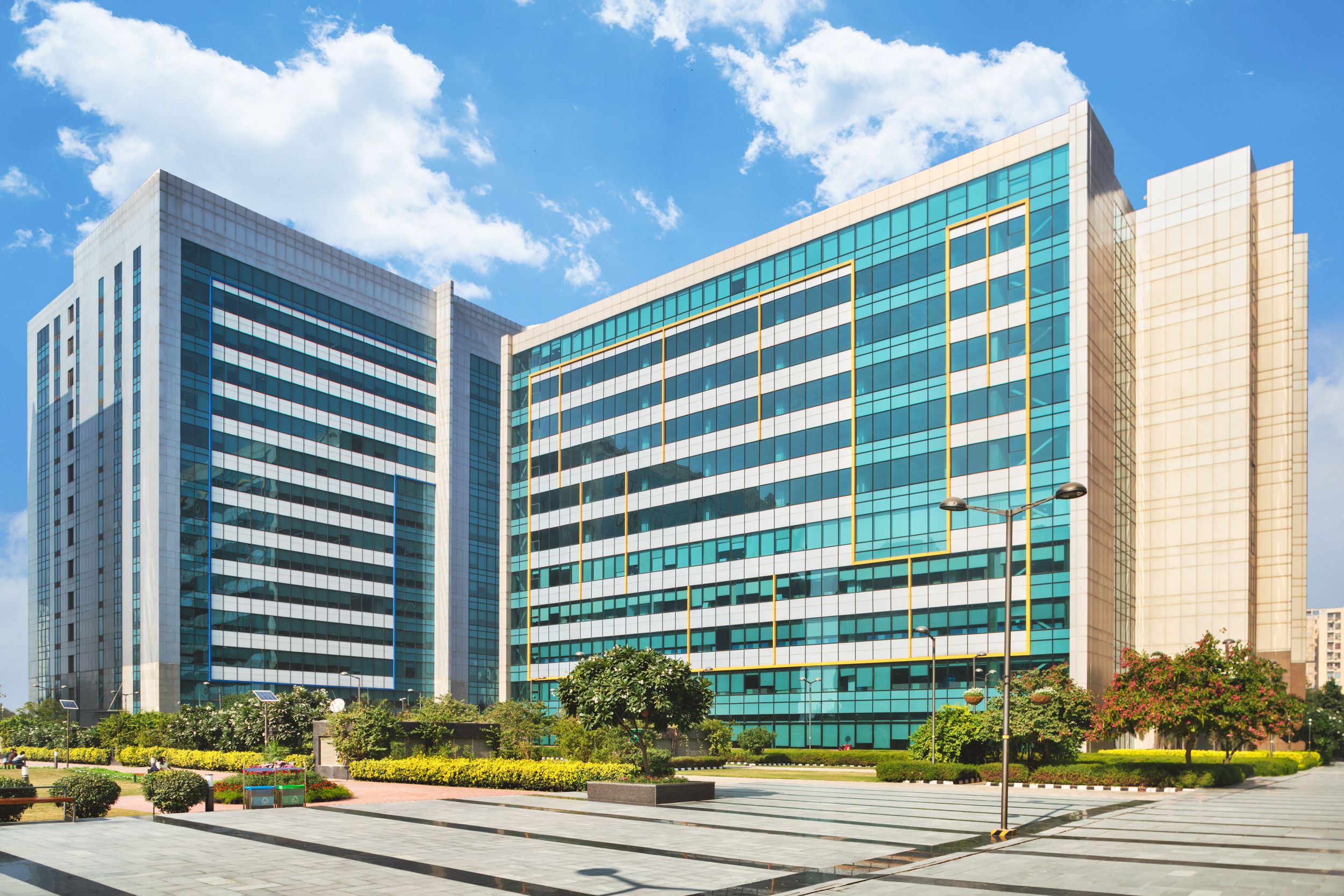 Modern office towers in Gurugram, India. Glass facade, corporate workspace, Brookfield India REIT property.