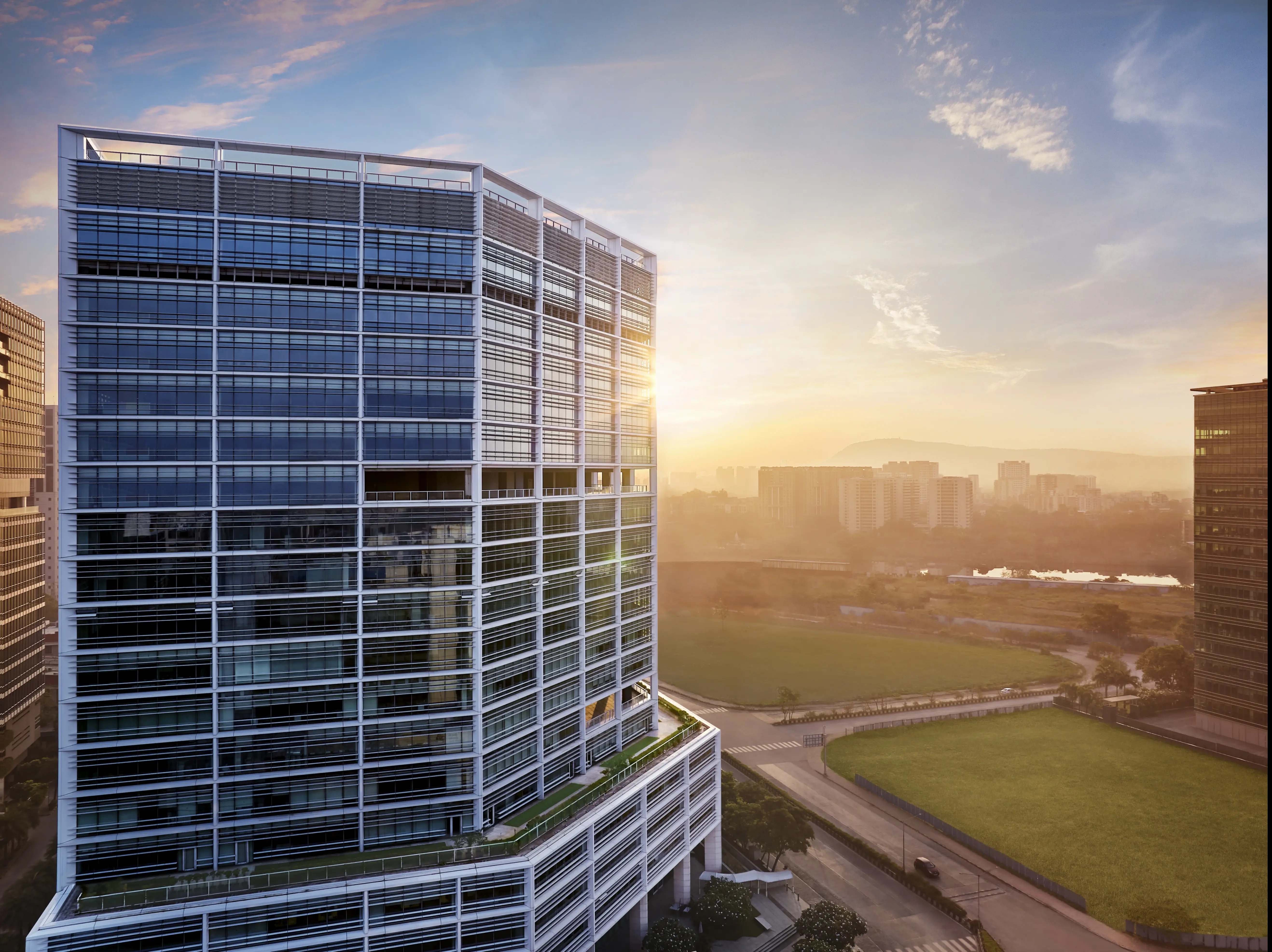 Modern office building exterior, glass and steel architecture, Brookfield India REIT property.