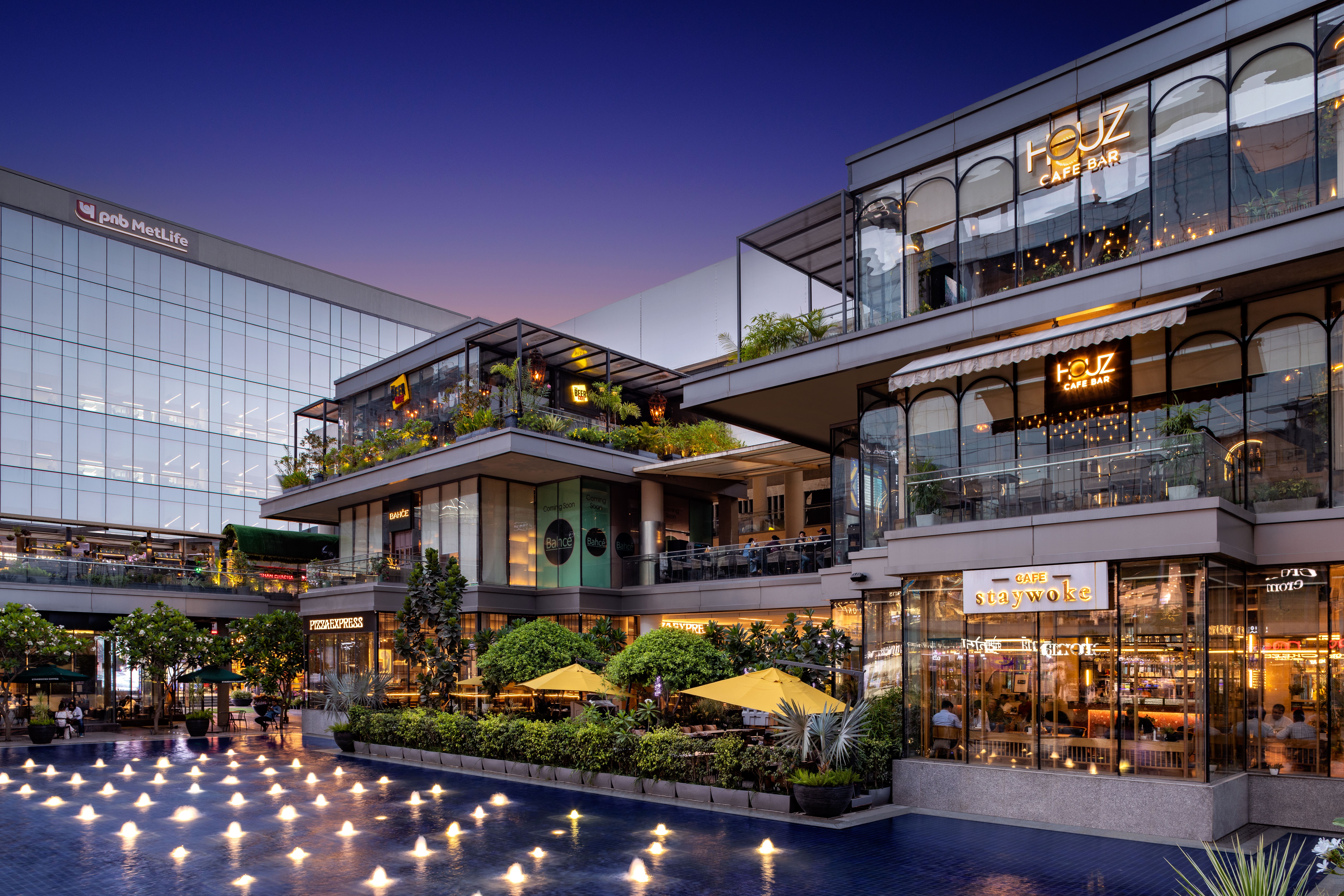 Vibrant food court with diverse dining options in a modern Indian shopping mall.