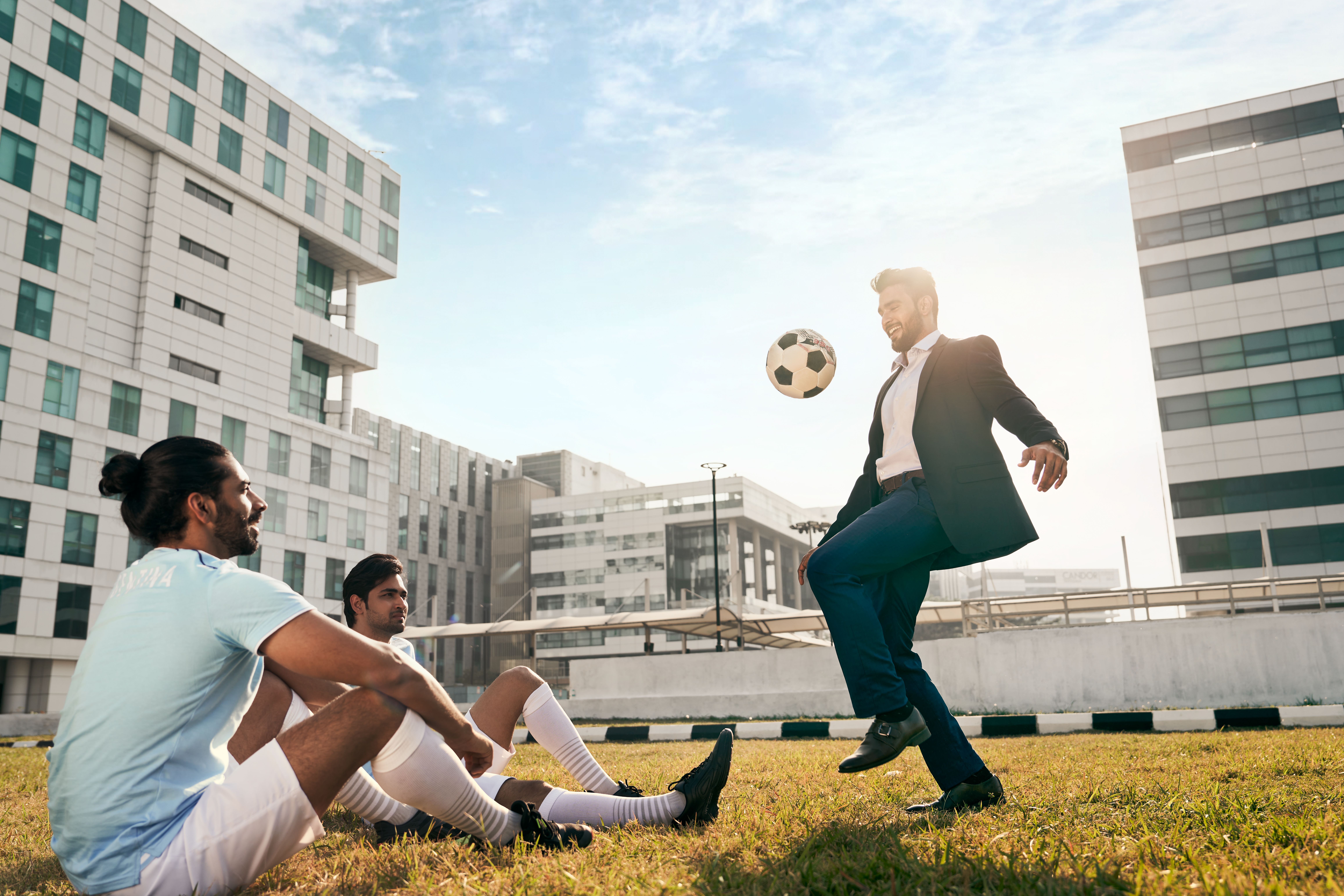 Outdoor sports area with green field, basketball court, and recreational facilities.