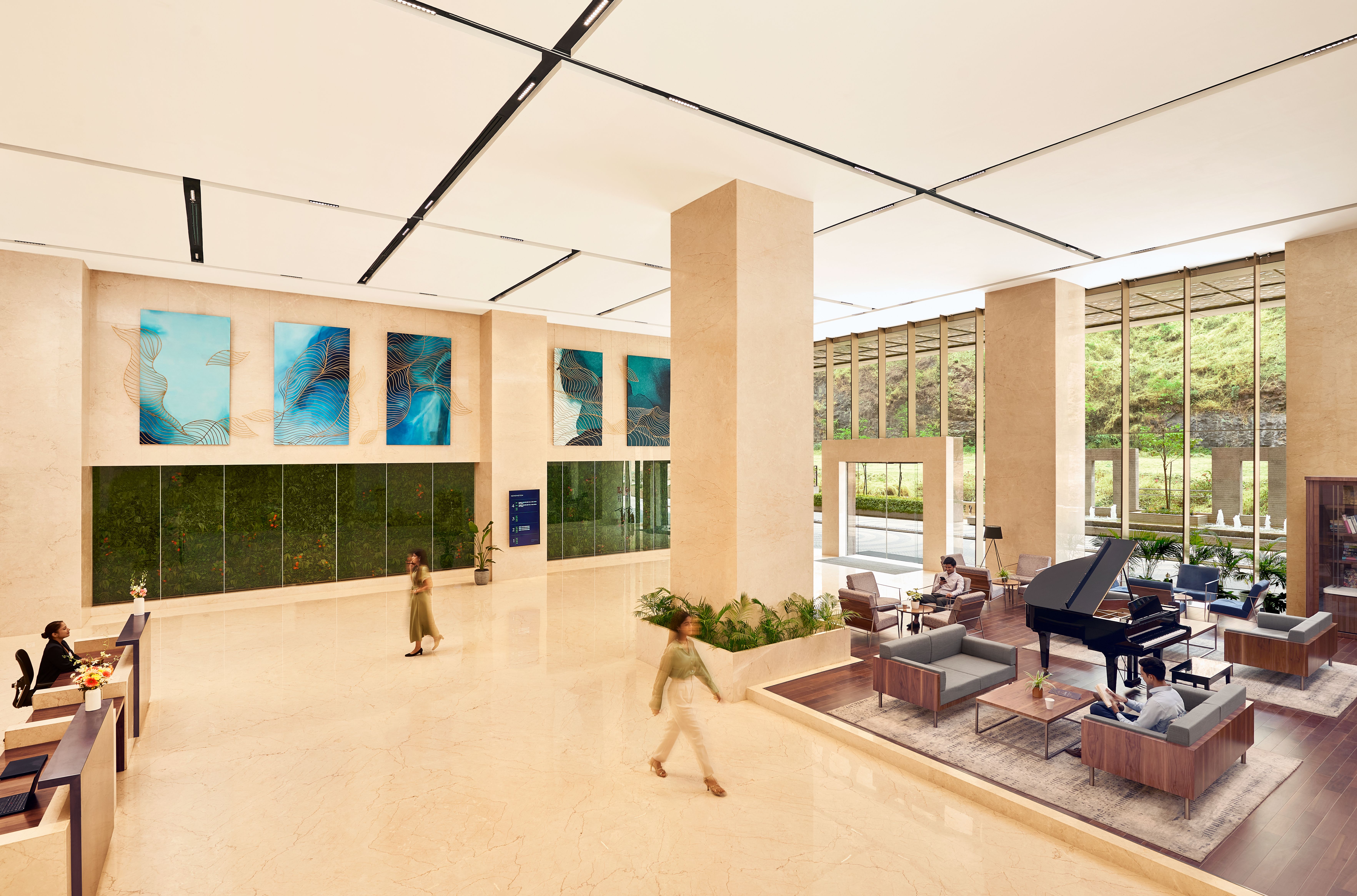 Modern hotel lobby with marble floors and elegant seating. Upscale reception area.