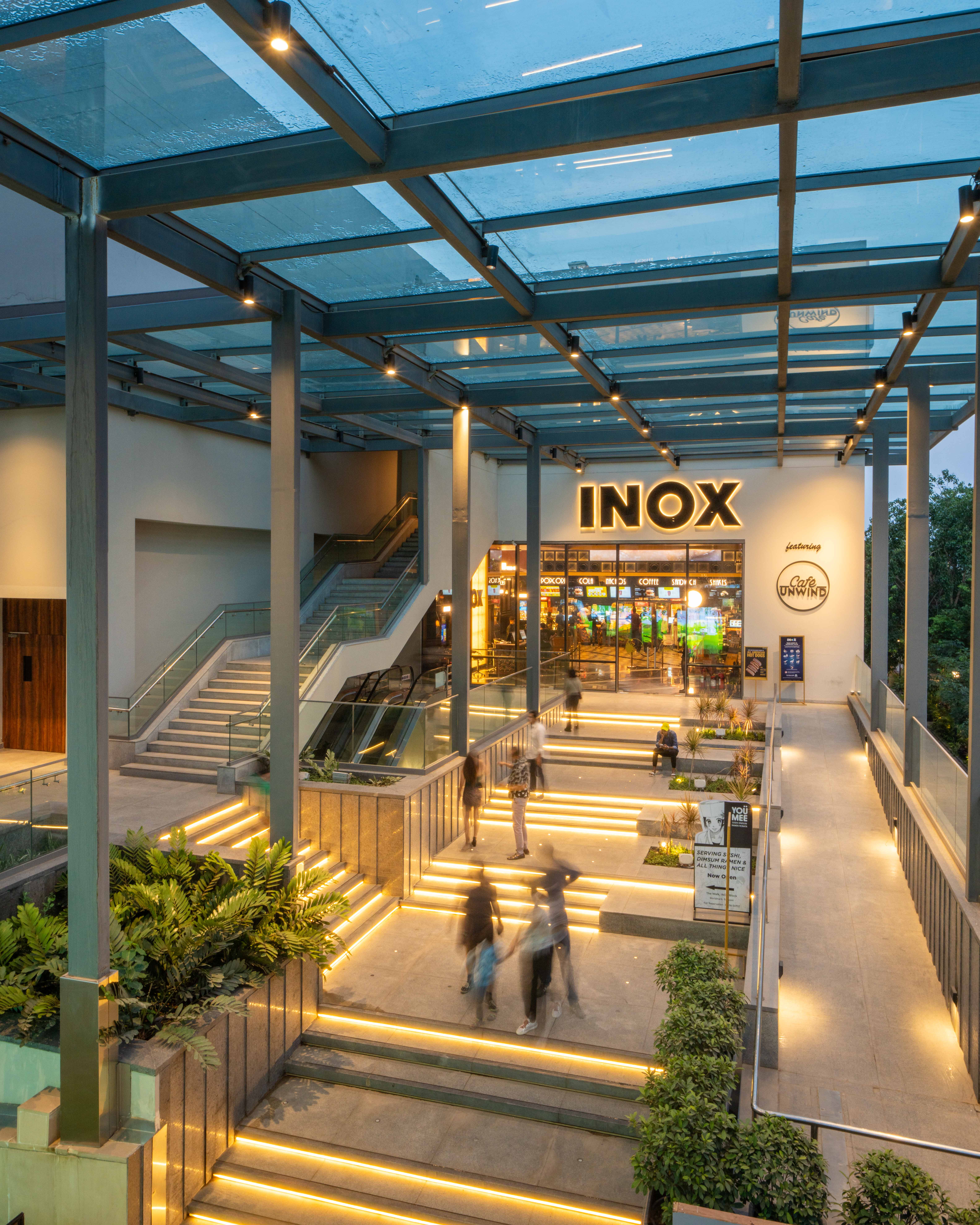 Modern multiplex cinema interior with plush seating and a large screen.