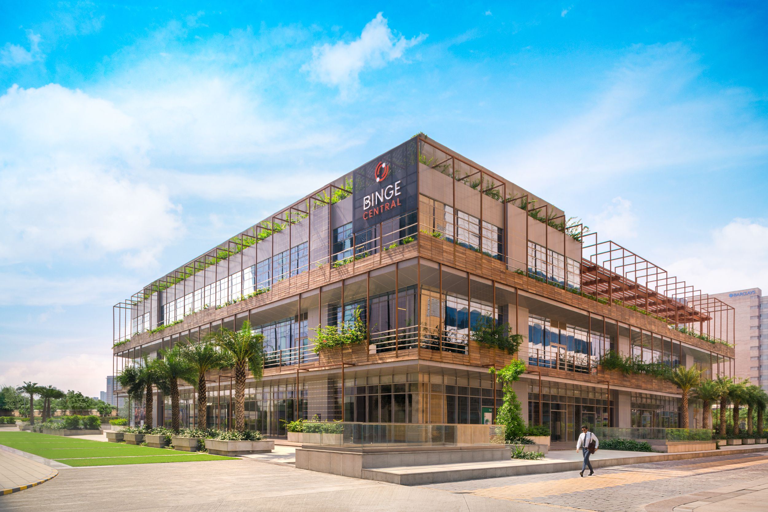 Modern mall interior with shoppers browsing retail stores and enjoying dining options.