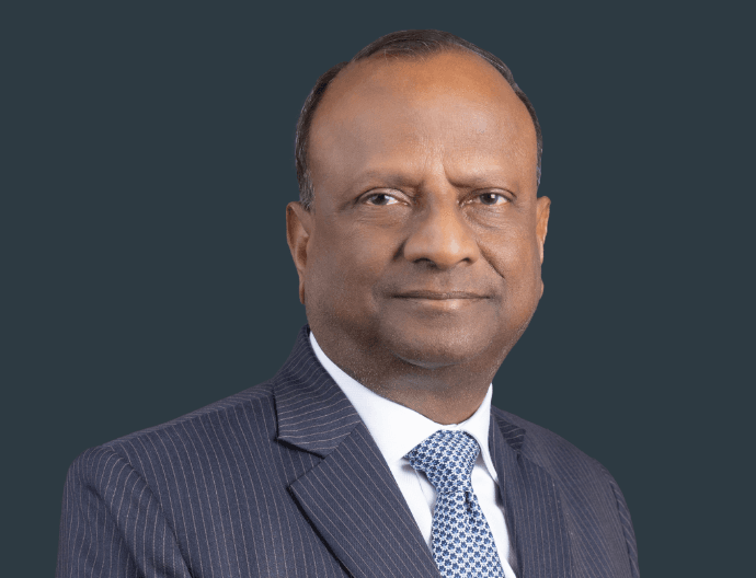 Rajnish Kumar, former SBI Chairman, speaks at a real estate industry event.
