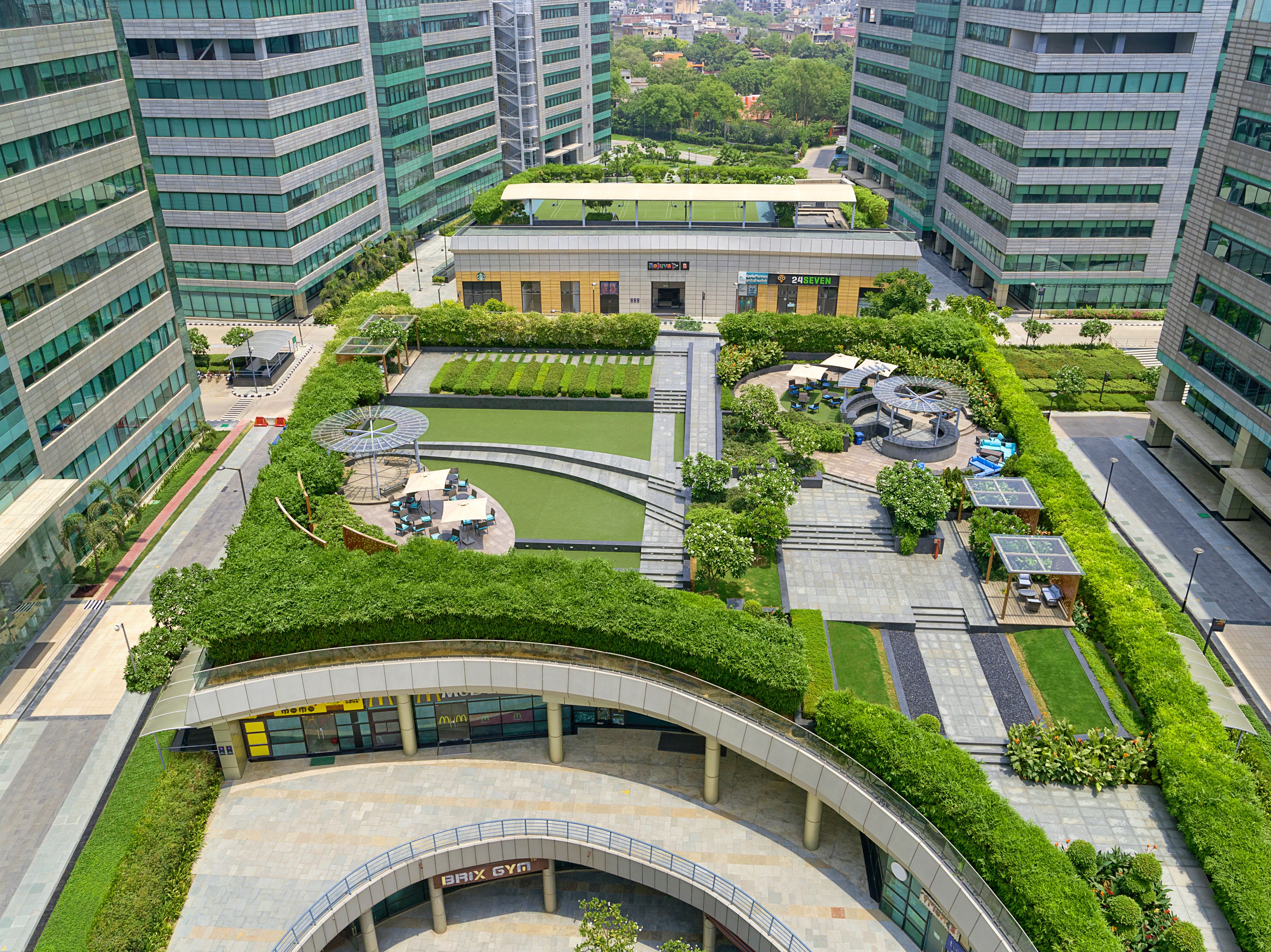 Rooftop terrace garden with lush greenery and modern seating in Mumbai, India.