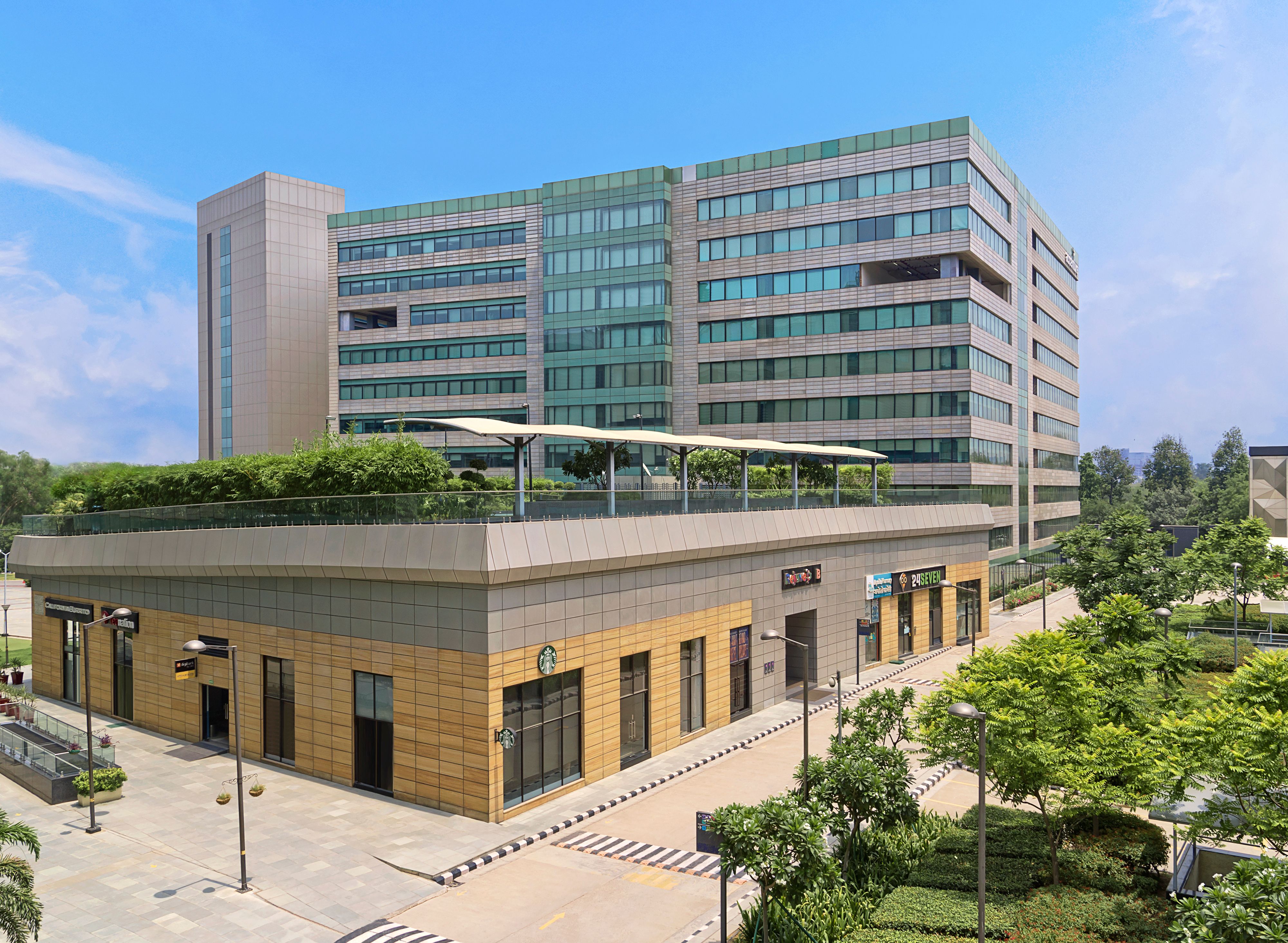 Modern retail zone with shops and walkways, bustling with activity.