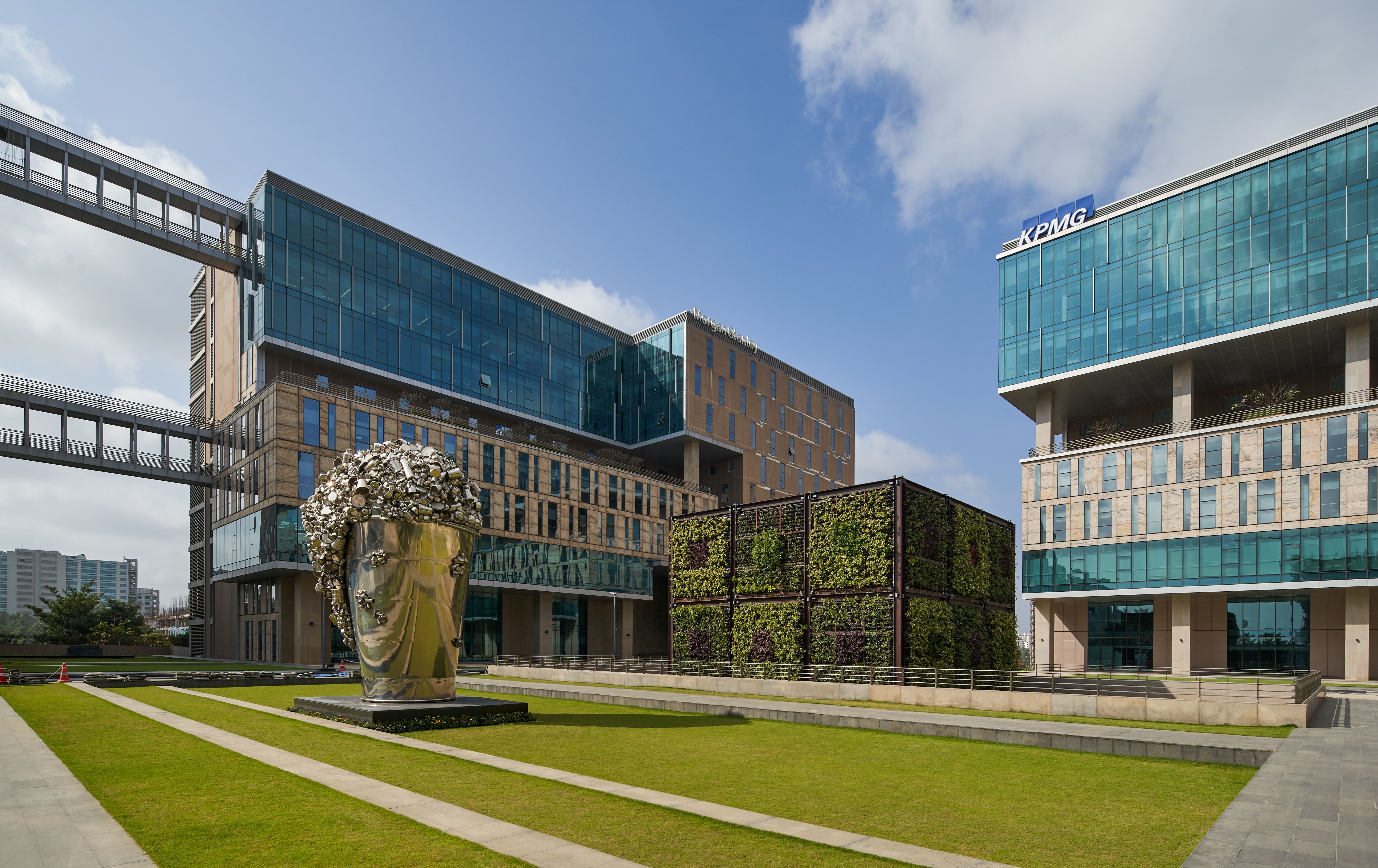 Modern sustainable business park with green spaces and solar panels, promoting eco-friendly workplaces.